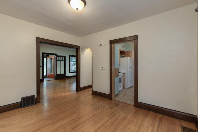 spare room with light hardwood / wood-style floors