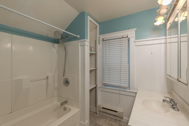 bathroom featuring vanity, a baseboard heating unit, and washtub / shower combination