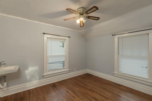 unfurnished room with ceiling fan, dark hardwood / wood-style flooring, and vaulted ceiling