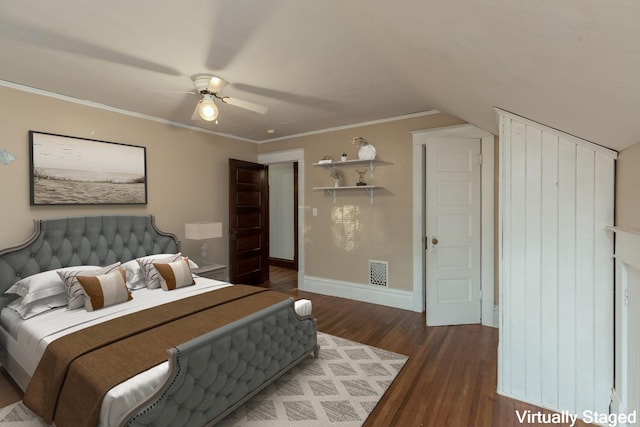 bedroom with dark wood-type flooring, ornamental molding, and ceiling fan