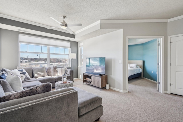 living area featuring carpet flooring, crown molding, baseboards, and ceiling fan