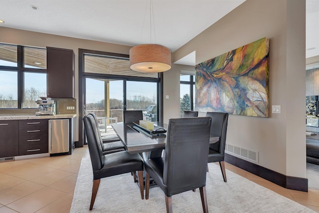 tiled dining space with a healthy amount of sunlight