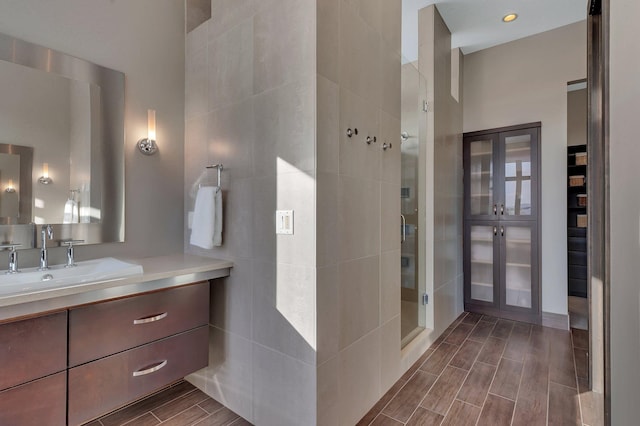 bathroom with vanity and a shower with door