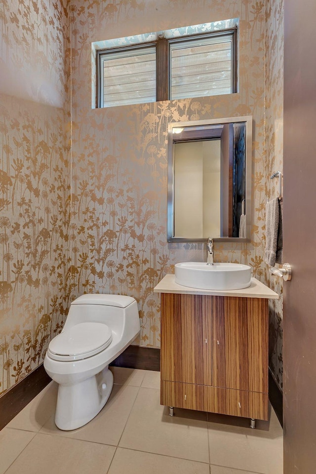 bathroom featuring vanity, tile patterned floors, and toilet