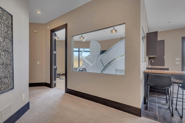 hallway featuring carpet flooring