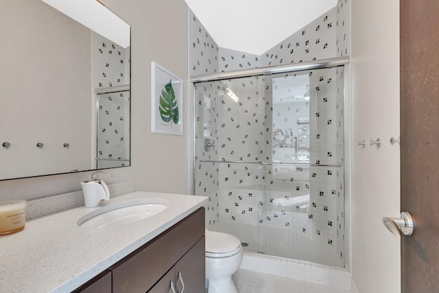 bathroom with vanity, lofted ceiling, toilet, and walk in shower