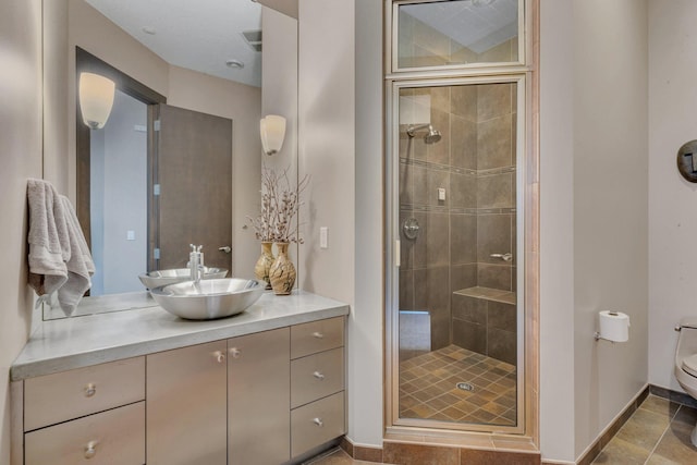 bathroom featuring vanity, an enclosed shower, and toilet