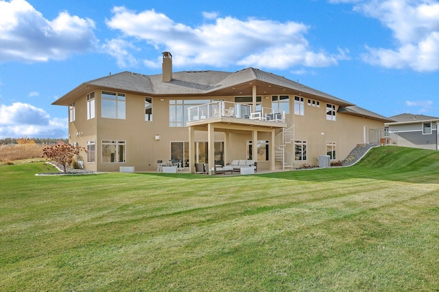 back of house with a balcony, a lawn, outdoor lounge area, central air condition unit, and a patio area