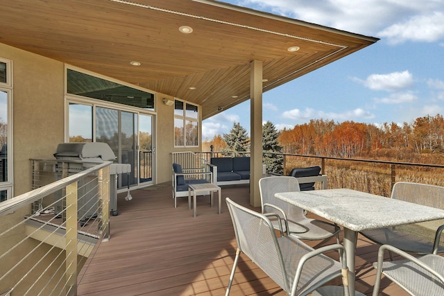 wooden terrace featuring an outdoor living space and grilling area