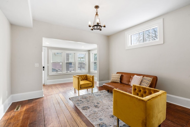 living room with an inviting chandelier and dark hardwood / wood-style floors