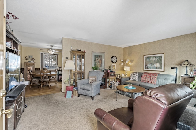 living room featuring ceiling fan and light carpet