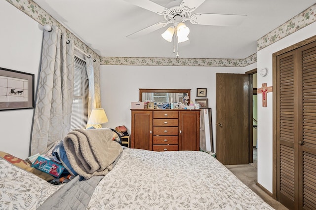 bedroom featuring multiple windows, a closet, ceiling fan, and carpet