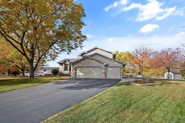 view of front of property with a garage and a front yard