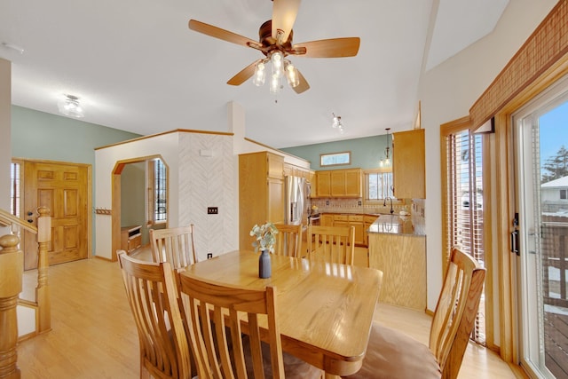 dining room with ceiling fan, light hardwood / wood-style floors, and sink