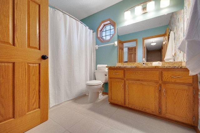 bathroom featuring tile patterned flooring, vanity, and toilet