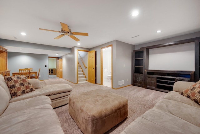 carpeted home theater room featuring ceiling fan