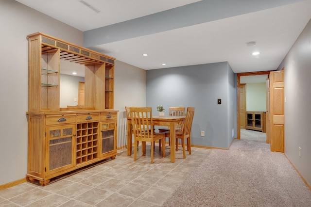 dining area featuring light colored carpet