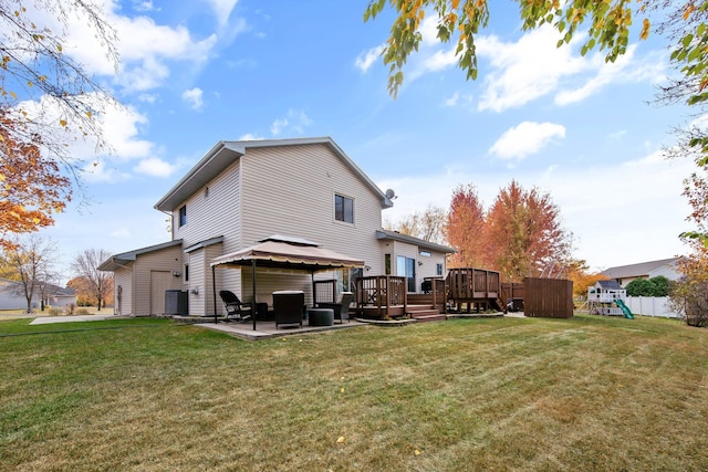 back of property with central air condition unit, a gazebo, a deck, a lawn, and a playground