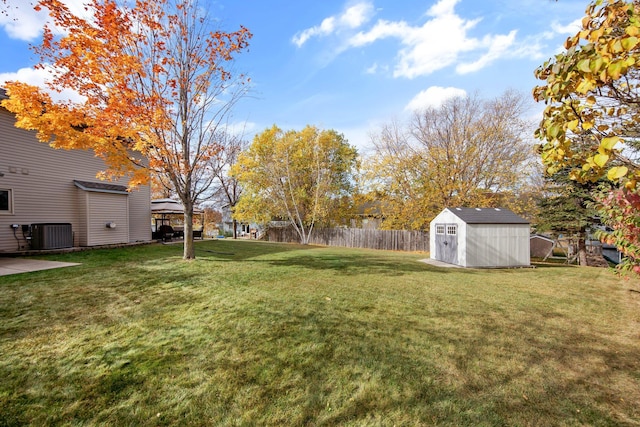 view of yard with cooling unit and a storage unit