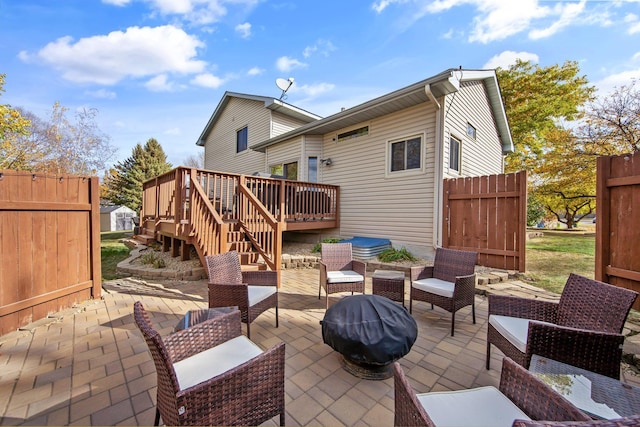 back of property with an outdoor living space, a patio, and a deck