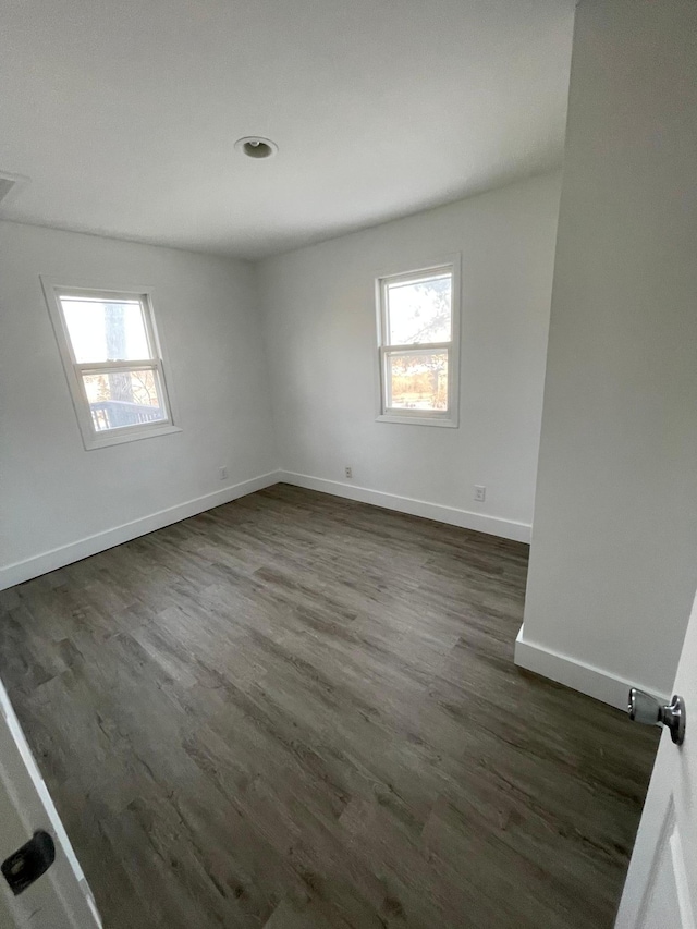 empty room with dark hardwood / wood-style floors