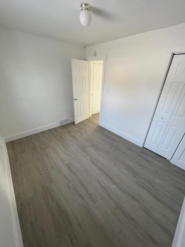 unfurnished bedroom featuring dark hardwood / wood-style floors