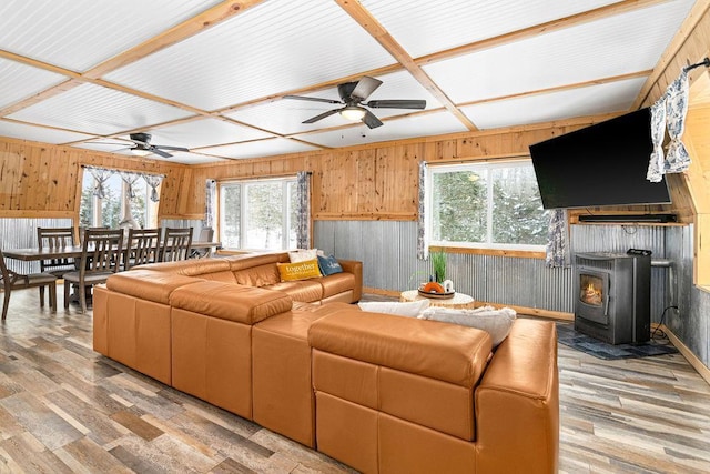 living room featuring plenty of natural light, wooden walls, and light hardwood / wood-style flooring