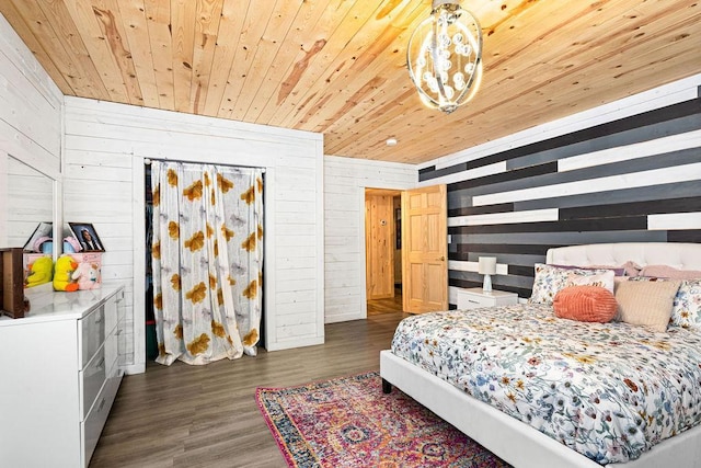 bedroom featuring dark hardwood / wood-style flooring, wooden walls, and wood ceiling