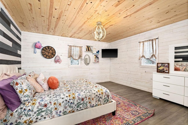 bedroom with wooden walls, wooden ceiling, and dark hardwood / wood-style floors