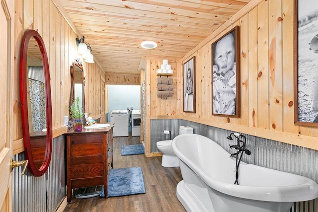 bathroom featuring hardwood / wood-style floors, wooden walls, a tub, vanity, and wooden ceiling