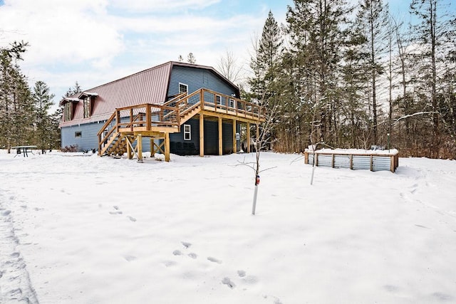 snow covered property featuring a deck