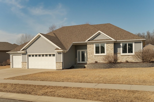 craftsman house featuring a garage, stone siding, a shingled roof, and concrete driveway