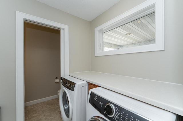 washroom with baseboards, laundry area, tile patterned floors, and washer and dryer