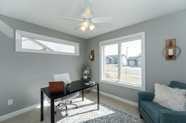 office area featuring carpet, baseboards, and a ceiling fan