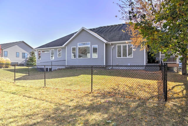 view of front of property with a shingled roof, fence, and a front lawn