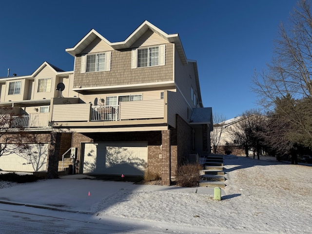 view of front of property with central AC unit, a garage, and a balcony