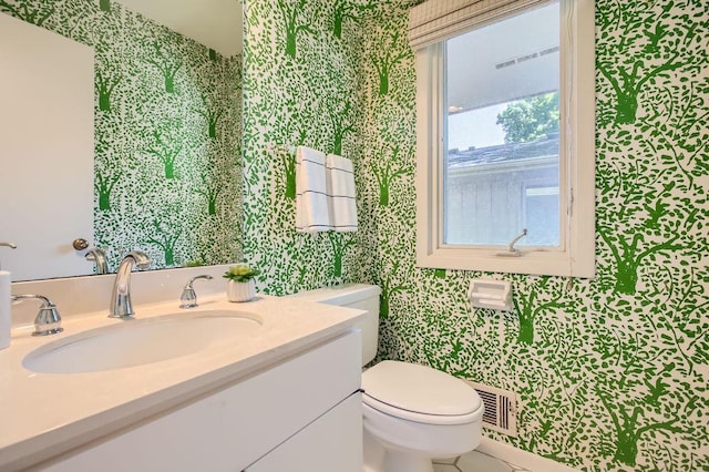 bathroom featuring visible vents, vanity, and toilet