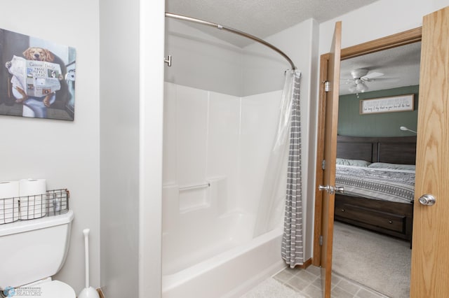 ensuite bathroom with a textured ceiling, shower / tub combo, connected bathroom, and toilet