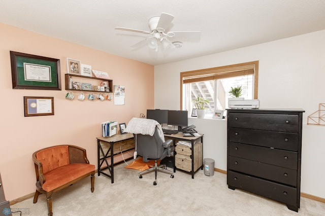 office with light carpet, a ceiling fan, and baseboards