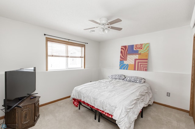 carpeted bedroom featuring ceiling fan and baseboards