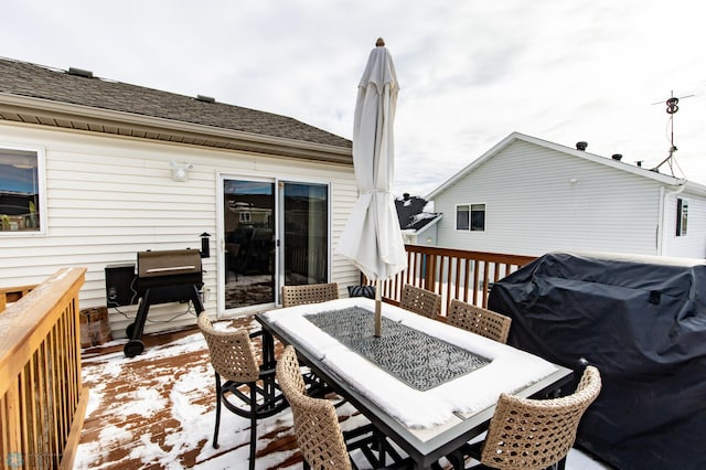 deck featuring outdoor dining space and area for grilling