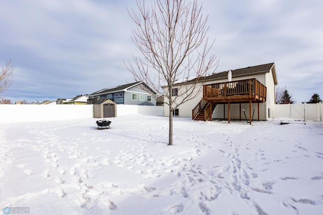 view of front of property with a fenced backyard, a storage shed, an outdoor structure, stairs, and a wooden deck