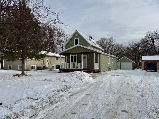 view of front of home with a garage, an outdoor structure, and a porch