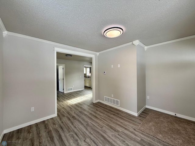 unfurnished room featuring hardwood / wood-style flooring, ornamental molding, and a textured ceiling