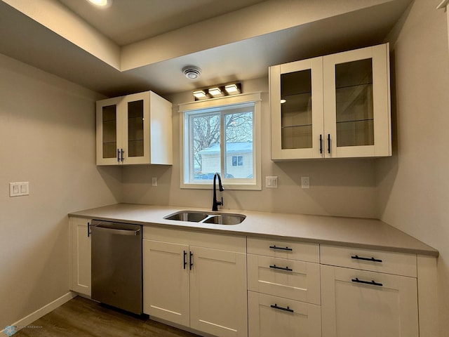 kitchen featuring dark hardwood / wood-style flooring, sink, white cabinets, and dishwasher