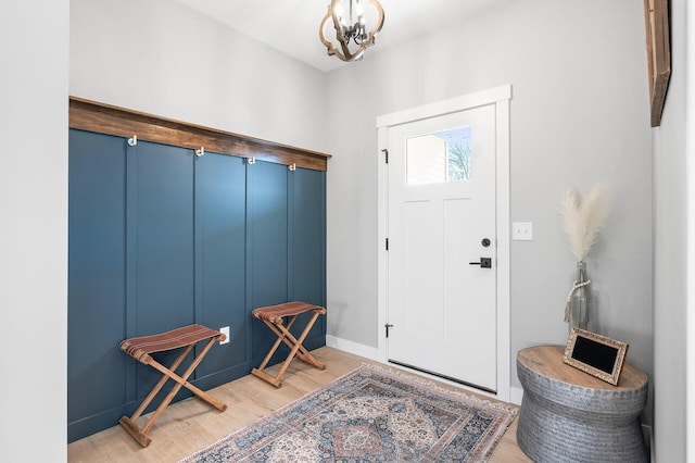 foyer entrance featuring an inviting chandelier and light wood-type flooring