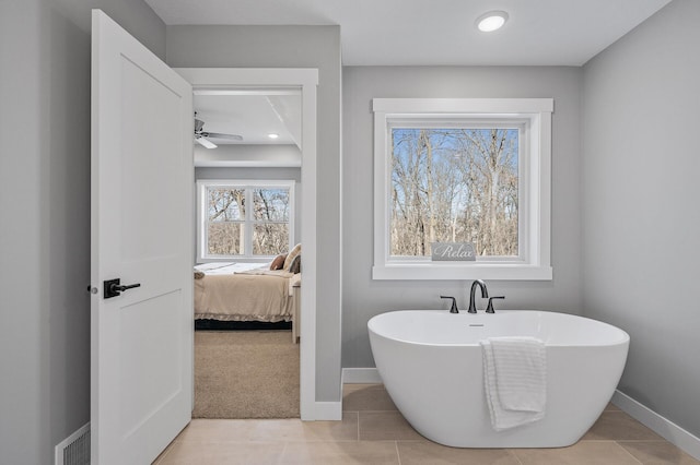 bathroom featuring a washtub and tile patterned floors