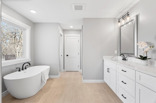 bathroom featuring vanity and a tub