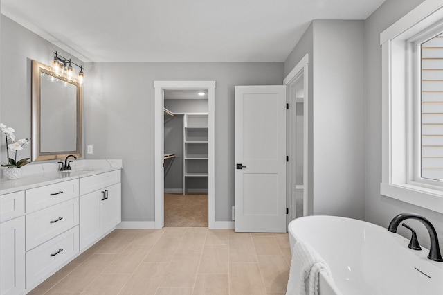 bathroom featuring vanity and a bath