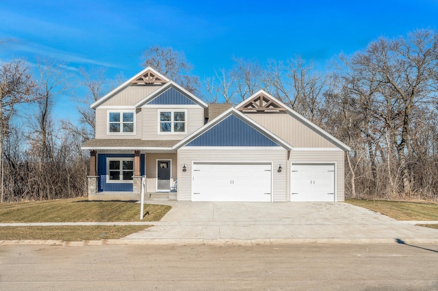 craftsman inspired home with a garage, a front yard, and a porch